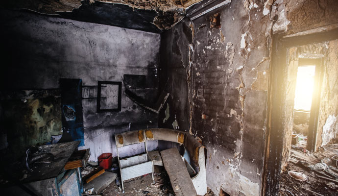 A fire damaged room with furniture and contents