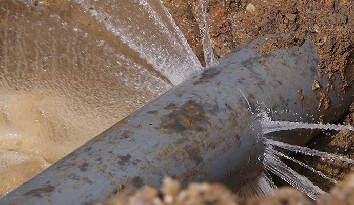 Broken water pipe spraying out water Broken water pipe spraying out water